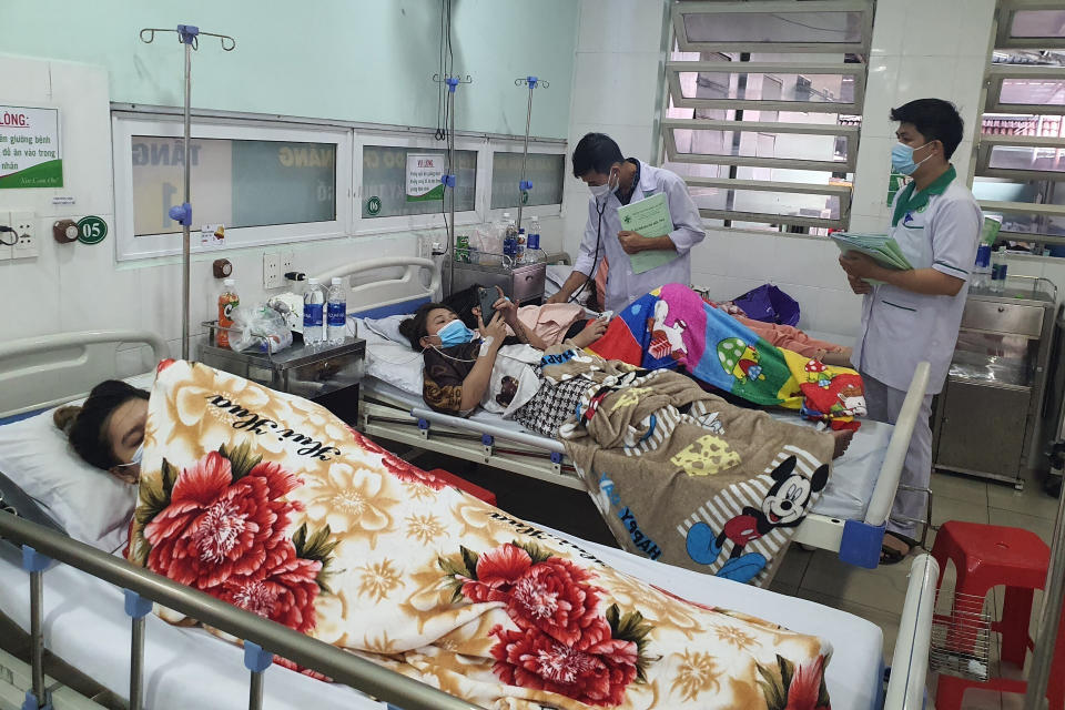 Victims of karaoke parlor fire are treated in a hospital Wednesday, Sept. 7, 2022, in Thuan An city, southern Vietnam. Over a dozen people died in the fire local media reported. (Duong Trei Tuong/VNA via AP)