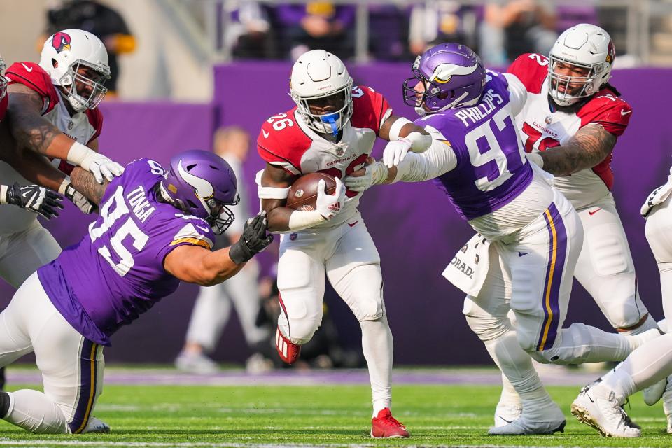 Oct 30, 2022; Minneapolis, Minnesota, USA; Arizona Cardinals running back Eno Benjamin (26) runs with the ball against the Minnesota Vikings in the second quarter at U.S. Bank Stadium.