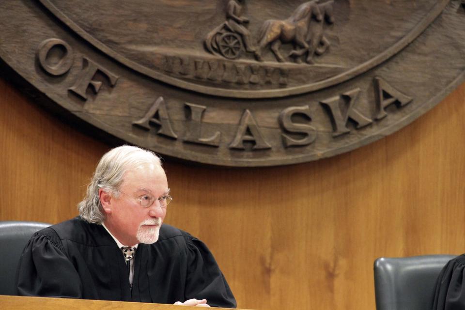 FILE - Alaska Supreme Court Justice Craig Stowers listens to arguments in a lawsuit that claims state policy on fossil fuels is harming the constitutional right of young Alaskans to a safe climate on Oct. 9, 2019, in Anchorage, Alaska. The Alaska Supreme Court on Friday, Jan. 28, 2022, upheld the dismissal of a lawsuit filed by 16 Alaska youths, who claimed long-term effects of climate change will devastate Alaska and interfere with their individual constitutional rights. (AP Photo/Mark Thiessen, File)