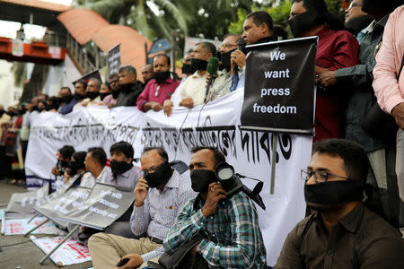 FILE PHOTO: Journalists hold banners and placards as they protest against the newly passed Digital Security Act in front of the Press Club in Dhaka, Bangladesh, October 11, 2018. REUTERS/Mohammad Ponir Hossain/File Photo