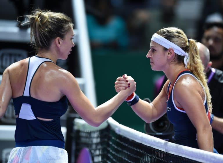 Slovakia's Dominika Cibulkova (R) eliminated Romania's Simona Halep from the $7 million WTA Finals tournament in Singapore