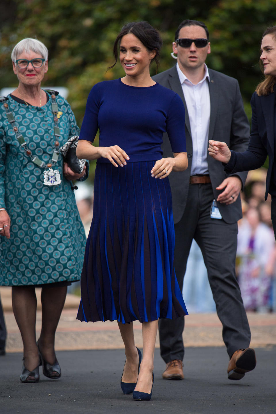 <p>Wearing a bespoke Givenchy jumper and pleated skirt, the Duchess of Sussex stuck to her favourite colour palette while on a walkabout in Rotorua on October 31. <em>[Photo: Getty]</em> </p>