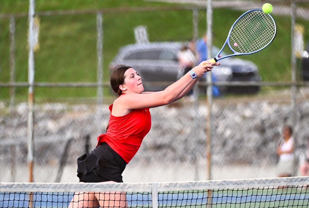Edgewood’s Maris Holmes hits a backhand volley during her No. 2 doubles match during the tennis match at Bloomington North on Tuesday, April 16, 2024.