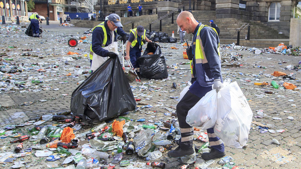 Workers, pictured here clearing rubbish from the centre of Leeds.