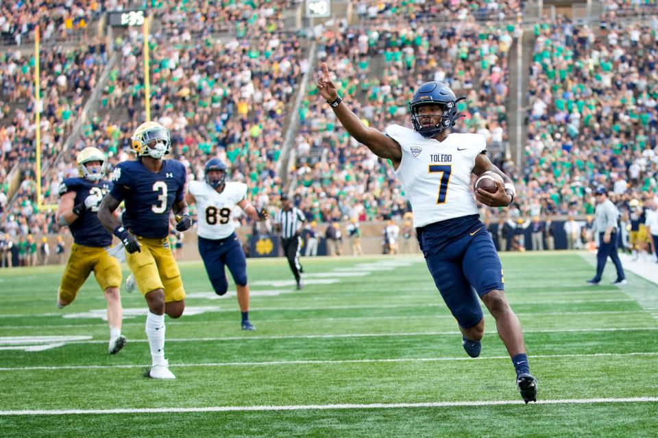 Toledo quarterback Dequan Finn (7) scores a touchdown in the second half of an NCAA college football game against Notre Dame in South Bend, Ind., Saturday, Sept. 11, 2021. Notre Dame won 32-29. (AP Photo/AJ Mast)