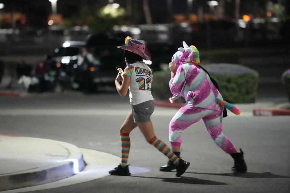 Two girls mock a group of people watching the Maricopa County early ballot drop box on Oct. 24, 2022, in Mesa.