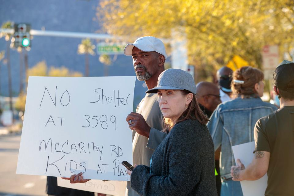 Norman and Kristin Jacobs of Palm Springs protest a plan to locate a  homeless navigation center on McCarthy Road during a demonstration outside city hall in Palm Springs, Calif., on Thursday, Jan. 27, 2022.