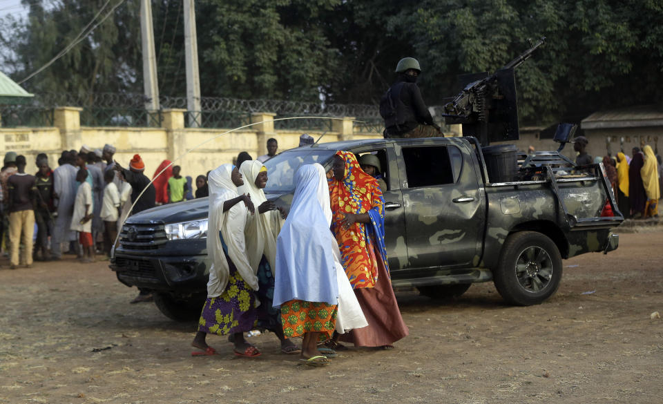 Parents are reunited with their daughters in Jangabe, Nigeria, Wednesday, March 3, 2021. More than 300 schoolgirls kidnapped last week in an attack on their school in northwest Nigeria have arrived in Jangabe after been freed on Tuesday. The Girls were abducted few days ago from Government Girls Secondary School in Jangabe in Zamfara state (AP Photo/Sunday Alamba)