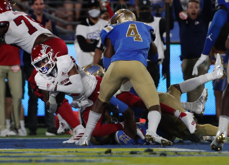 PASADENA, CA - SEPTEMBER 18, 2021: Fresno State Bulldogs wide receiver Jalen Cropper (5) dives into the end zone against UCLA Bruins defensive back Stephan Blaylock (4) at the Rose Bowl on September 18, 2021 in Pasadena, California.(Gina Ferazzi / Los Angeles Times)