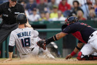 Miami Marlins' Joey Wendle scores as Washington Nationals catcher Keibert Ruiz can't make the tag in time during the third inning of a baseball game at Nationals Park, Friday, July 1, 2022, in Washington. (AP Photo/Alex Brandon)
