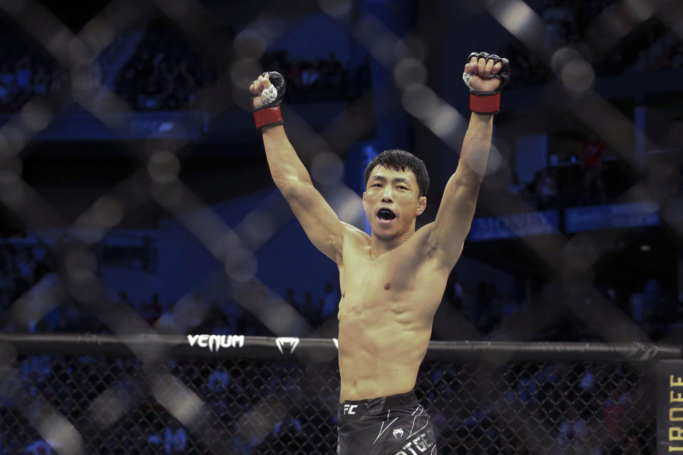 Danaa Batgerel celebrates his win of a UFC 261 mixed martial arts bout, Saturday, April 24, 2021, in Jacksonville, Fla. It is the first UFC event since the onset of the COVID-19 pandemic to feature a full crowd in attendance. (AP Photo/Gary McCullough)