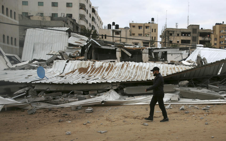 A Palestinian inspects the damage of destroyed building belongs to Hamas ministry of prisoners hit by Israeli airstrikes in Gaza City, early Friday, March 15, 2019. Israeli warplanes attacked militant targets in the southern Gaza Strip early Friday in response to a rare rocket attack on the Israeli city of Tel Aviv, as the sides appeared to be hurtling toward a new round of violence. (AP Photo/Adel Hana)