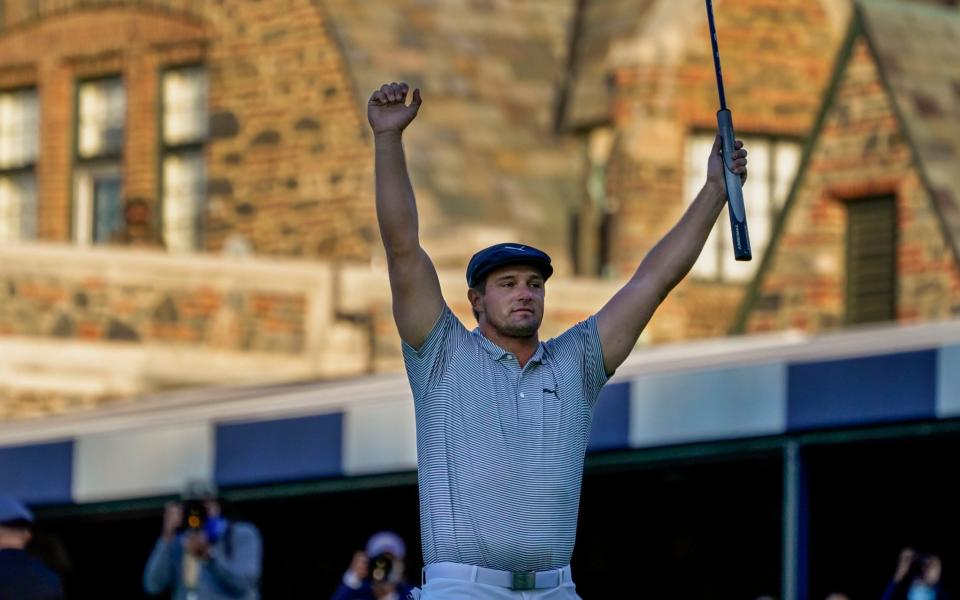 Bryson DeChambeau, of the United States, reacts after sinking a putt for par on the 18th hole  - AP