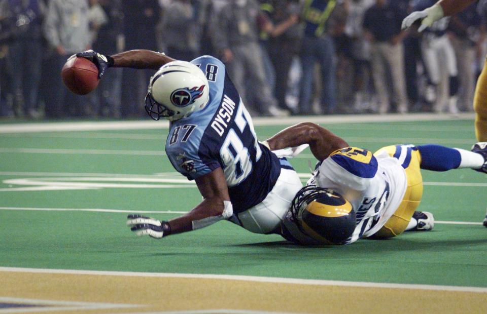 With St. Louis Rams linebacker Mike Jones hanging on, Tennessee Titans receiver Kevin Dyson stretches for the end zone on the final play of Super Bowl XXXIV inside the Georgia Dome Jan. 30, 2000. He was stopped at the 1.