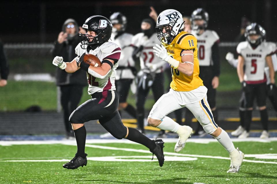 Badger’s Landon Nottestad (32) busts off a long run to the 1-yard line with Kettle Moraine’s Zach Donaldson (10) in pursuit in a WIAA Division 2 Level 3 playoff game Friday, November 3, 2023, at Kettle Moraine High School in Wales, Wisconsin.