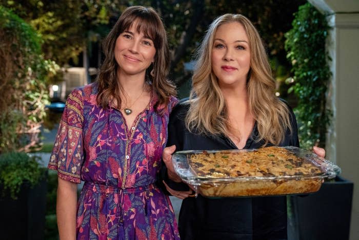 Linda and Christina, who's holding a casserole in a pan