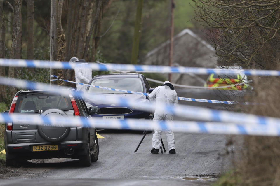 A forensic investigator from Police Service of Northern Ireland (PSNI) takes photos near to the sports complex in the Killyclogher Road area of Omagh, Co Tyrone, Northern Ireland Thursday, Feb. 23, 2023 where off-duty PSNI Detective Chief Inspector John Caldwell was shot. A senior Northern Ireland police officer is in critical but stable condition in a hospital after being shot by two masked men while he coached children’s soccer. Police said Thursday that a dissident Irish Republican Army splinter group is suspected of shooting the detective at a sports complex in the town of Omagh on Wednesday night. (Liam McBurney/PA via AP)