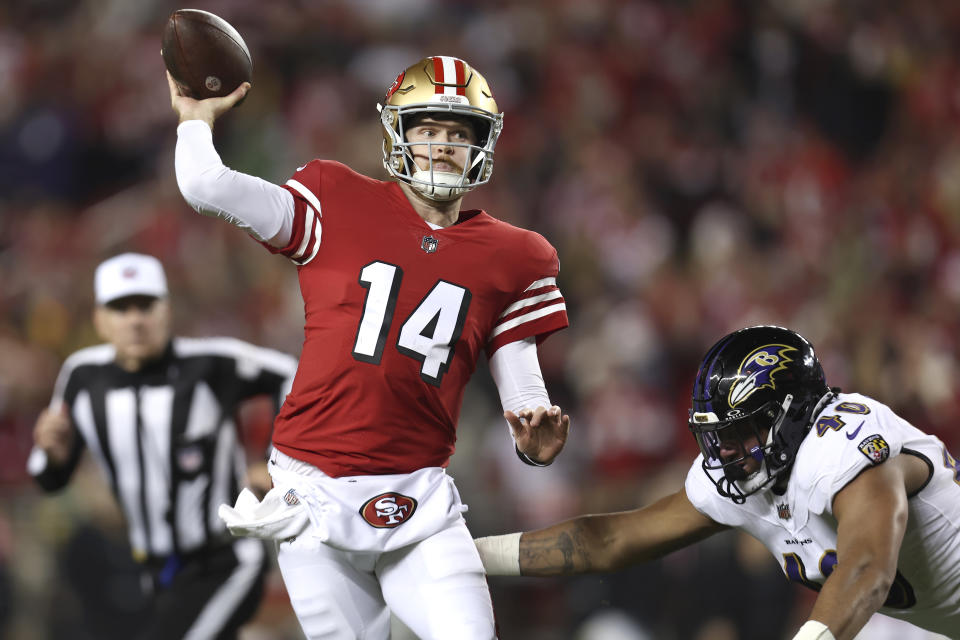 San Francisco 49ers quarterback Sam Darnold (14) passes in front of Baltimore Ravens linebacker Malik Harrison (40) during the second half of an NFL football game in Santa Clara, Calif., Monday, Dec. 25, 2023. (AP Photo/Jed Jacobsohn)