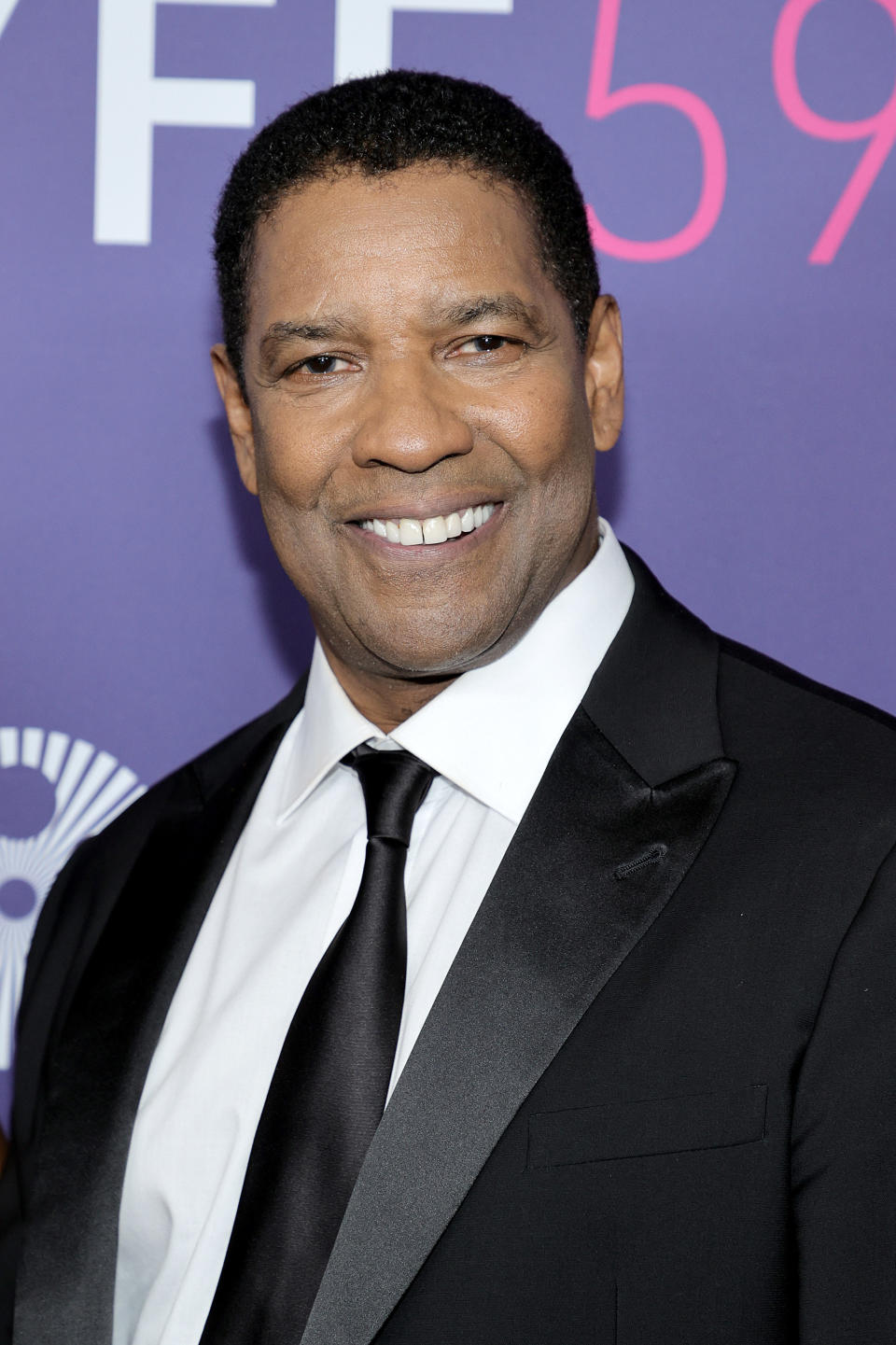 Denzel Washington smiling on the red carpet