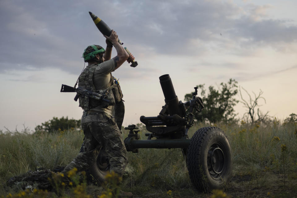 FILE - A Ukrainian serviceman of the 3rd Assault Brigade fires a 122mm mortar towards Russian positions at the front line, near Bakhmut, Donetsk region, Ukraine, Sunday, July 2, 2023. Fighting has intensified at multiple points along the 1,500-kilometer (930-mile) front line. Ukrainian forces are making steady progress along the northern and southern flanks of Bakhmut, in a semi-encirclement of the wrecked city that Russian forces have been occupying since May. (AP Photo/Alex Babenko, File)