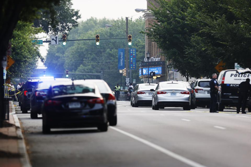 Cars and police gather around Altria Theater, the site of a shooting at the Huguenot High School graduation, Tuesday, June 6, 2023, in Richmond, Va. (Mike Kropf/Richmond Times-Dispatch via AP)