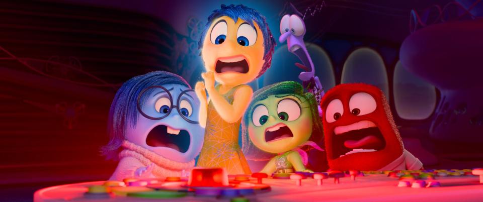 Inside Out 2 characters looking at red button