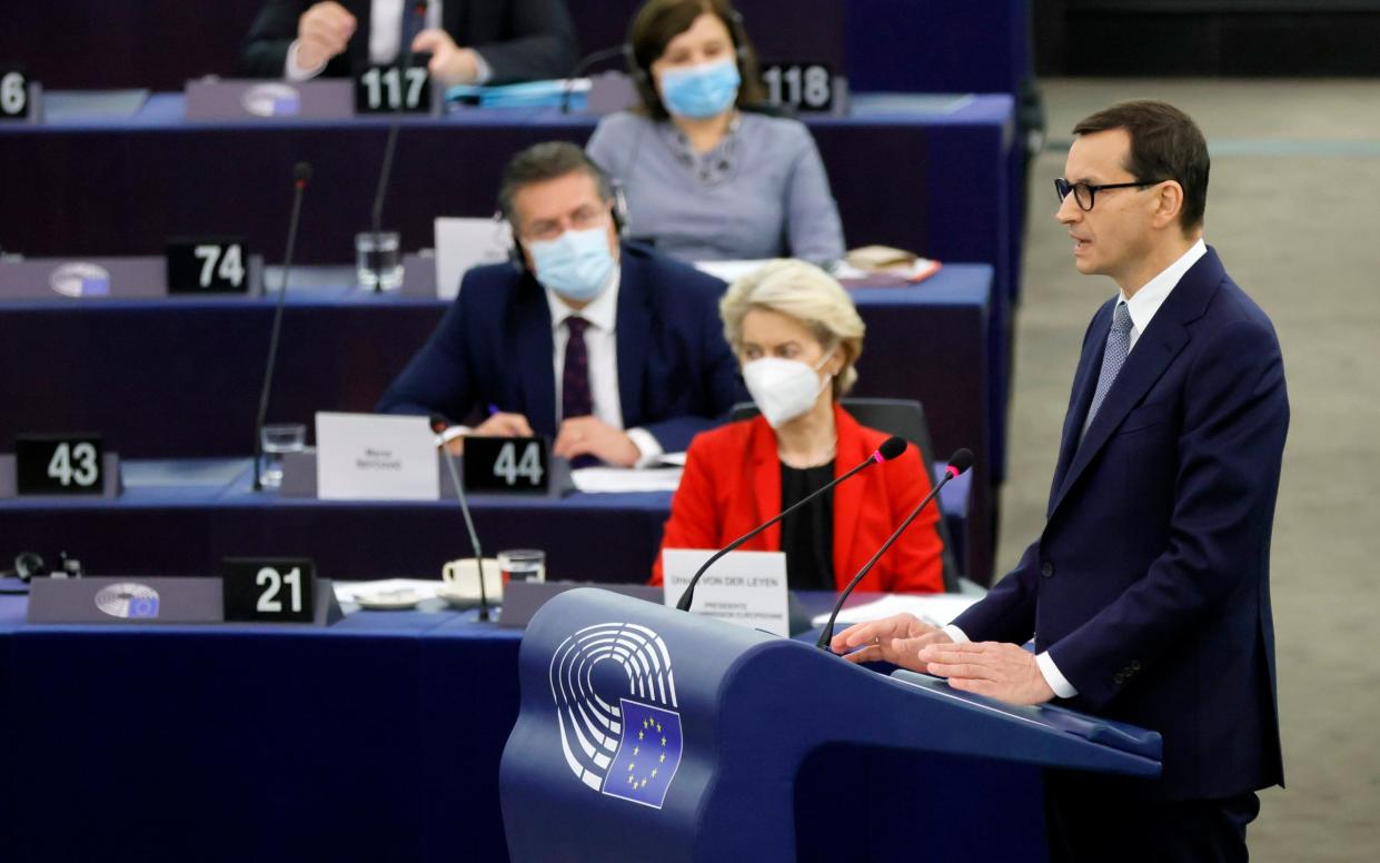 Poland's Prime Minister Mateusz Morawiecki, right,speaks in the European Parliament in Strasbourg on Tuesday as European Commission president Ursula von der Leyen , in red, listens. - Ronald Wittek /Pool EPA