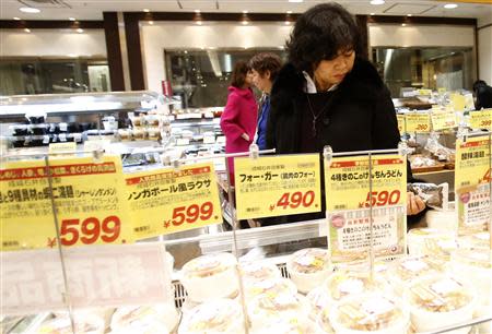 A customer looks at food products at a supermarket in Tokyo January 30, 2014. REUTERS/Yuya Shino