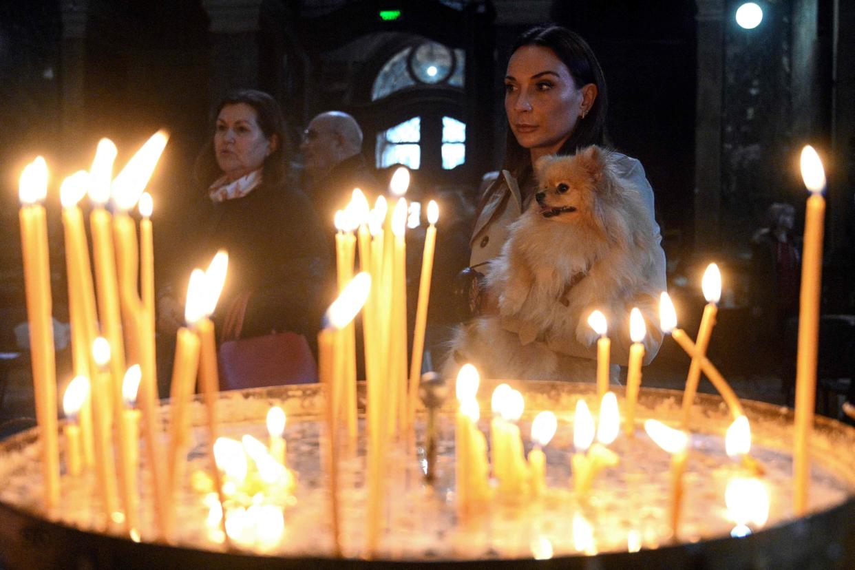 Orthodox believers attend a service at Saints Peter and Paul Garrison Church on the eve of Orthodox Easter in western Ukrainian city of Lviv (AFP via Getty Images)