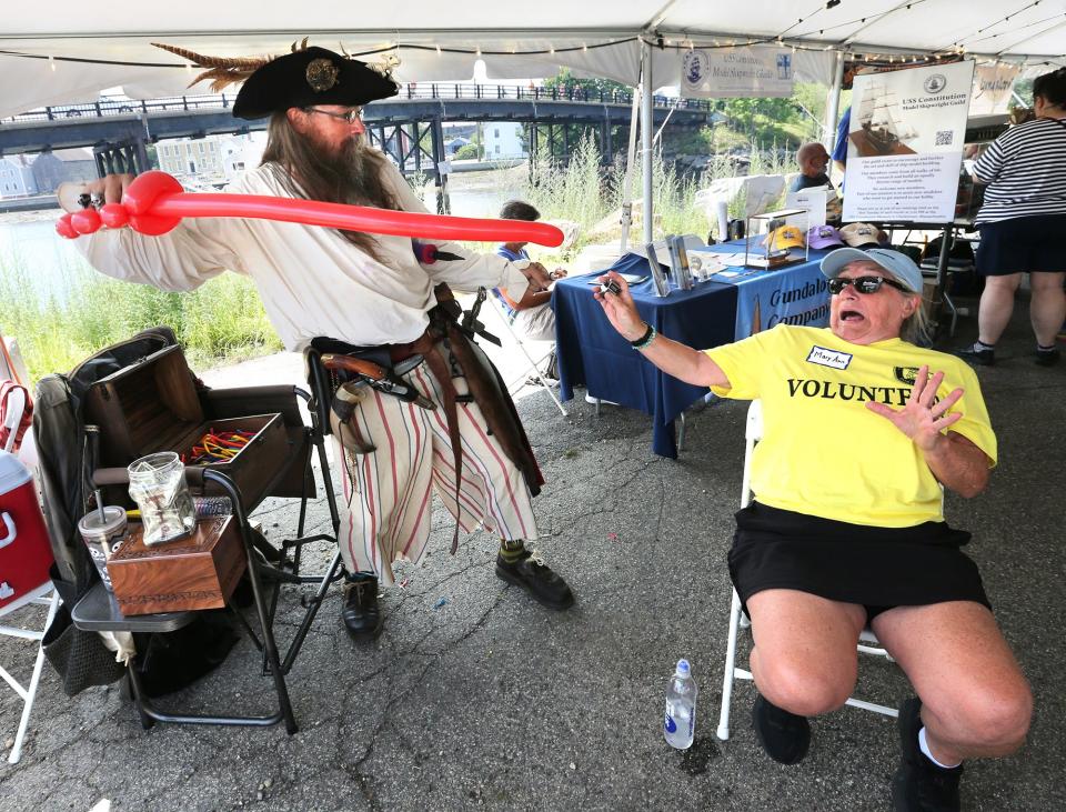 Pirate David Olsen, also known as Dastardly Dave, aims a balloon at volunteer Mary Ann Allsop during tall ship tours at the Sail Portsmouth event Friday, July 28, 2023.