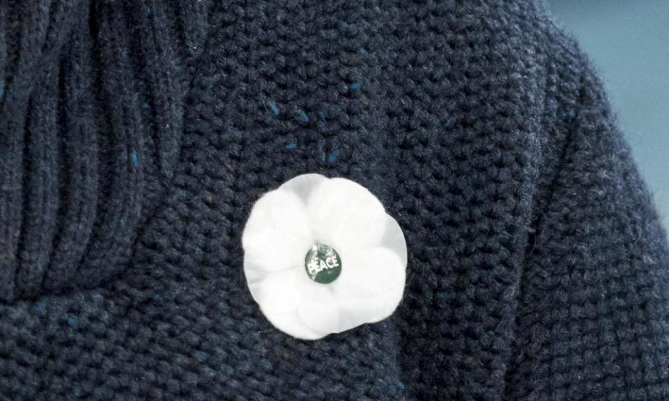 A white poppy on a knitted jumper
