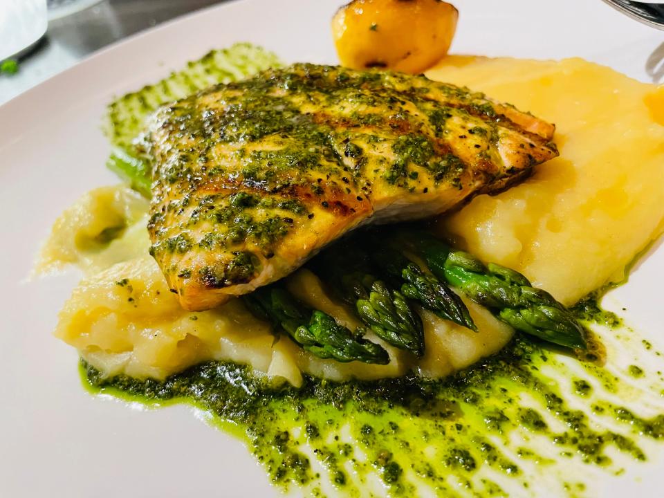 The Atlantic salmon at Bella is prepared with pesto and served with whipped potatoes and asparagus.