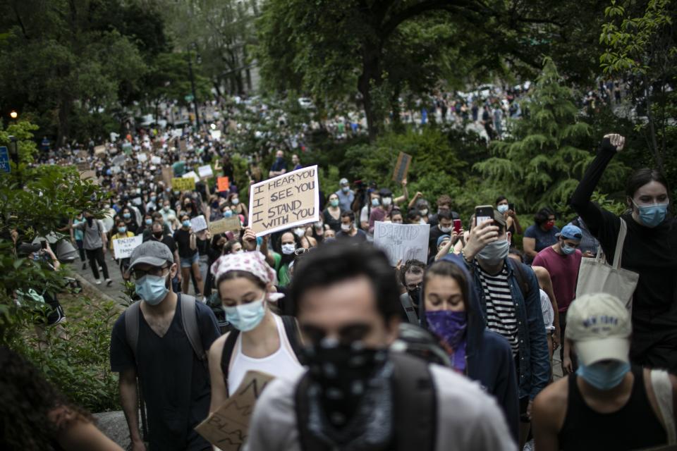 Protesters march through Carl Schurz Park during a solidarity rally calling for justice over the death of George Floyd, Thursday, June 4, 2020, in New York. Floyd died after being restrained by Minneapolis police officers on May 25. (AP Photo/Wong Maye-E)