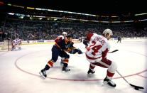 Panthers Jokinen goes for puck against Red Wings Chelios during their NHL game in Sunrise