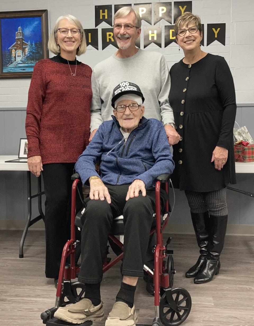 Richard Beaber is shown on his 100th birthday with his three children Patty Burson, from left, Jeff Beaber and Sherie Reese.