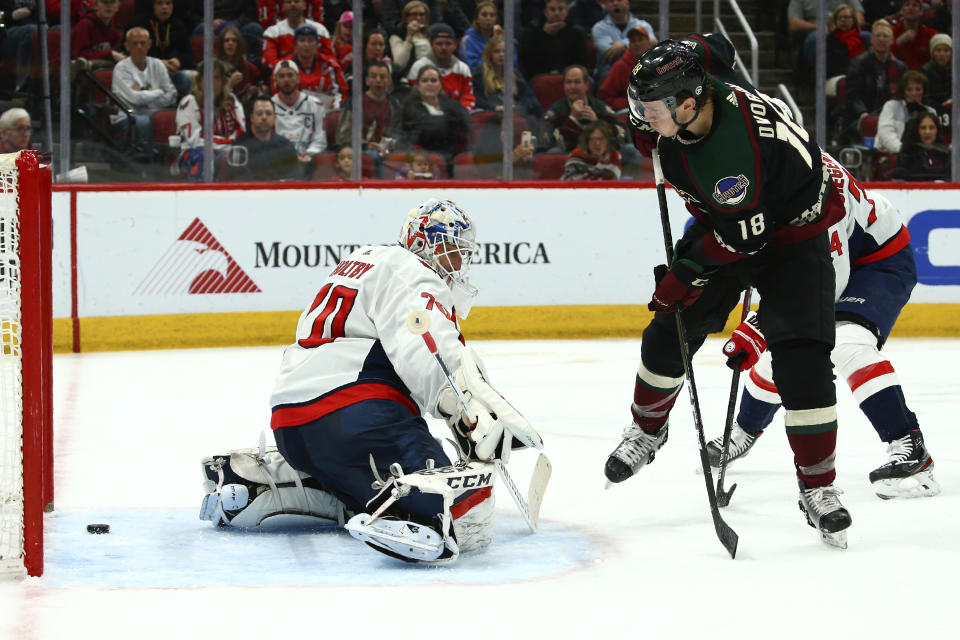 Arizona Coyotes center Christian Dvorak (18) scores a goal against Washington Capitals goaltender Braden Holtby, left, during the second period of an NHL hockey game Saturday, Feb. 15, 2020, in Glendale, Ariz. (AP Photo/Ross D. Franklin)