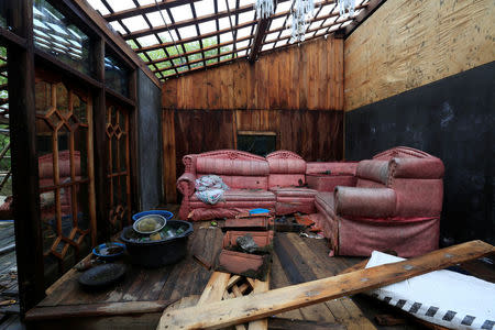 A sofa stands in an abandoned house after sea water hit Sriwulan village in Demak, Indonesia, February 2, 2018. REUTERS/Beawiharta