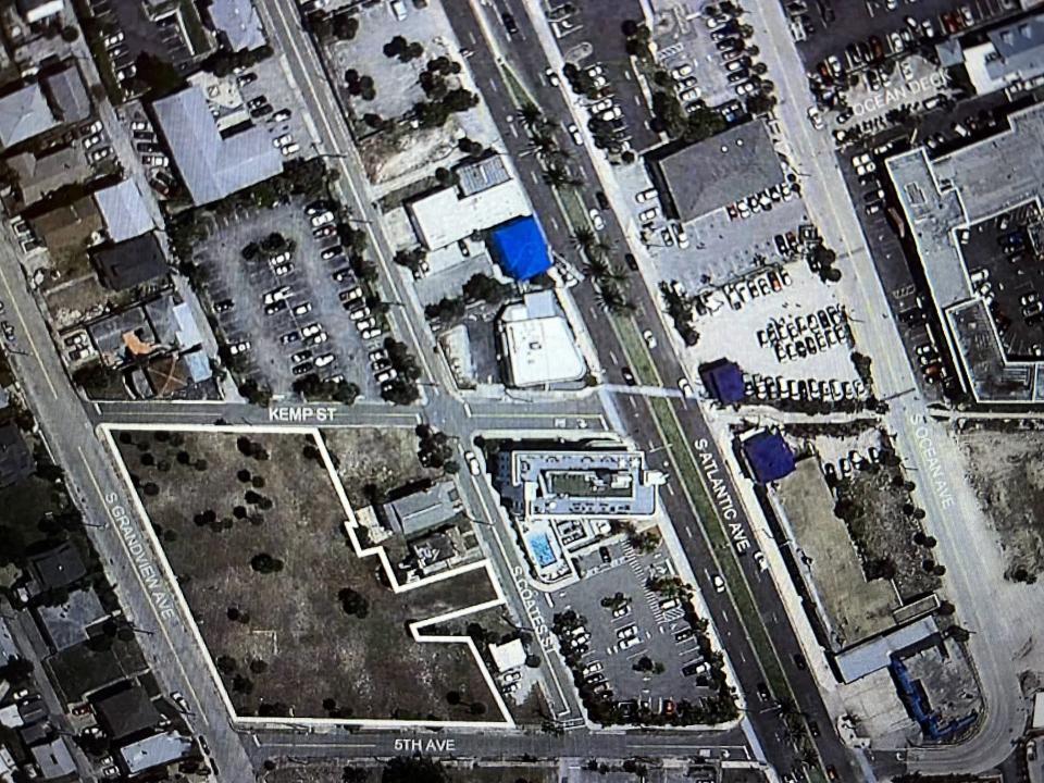 An aerial view of Daytona Beach's core tourist district between the Atlantic Ocean and Halifax River shows the vacant grassy field that's proposed to become the site of a new parking garage.