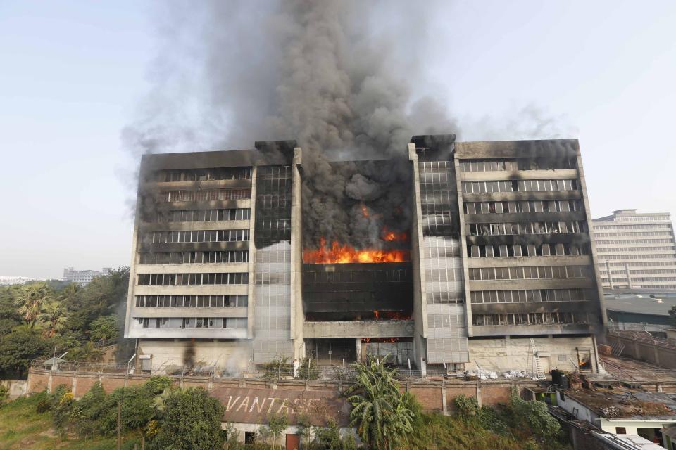 Smoke rises from a fire burning at a Standard Group garment factory in Gazipur