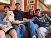 Mark Berkley and Susan Halper Berkley pose for a photo with their sons and dog in Maplewood, New Jersey