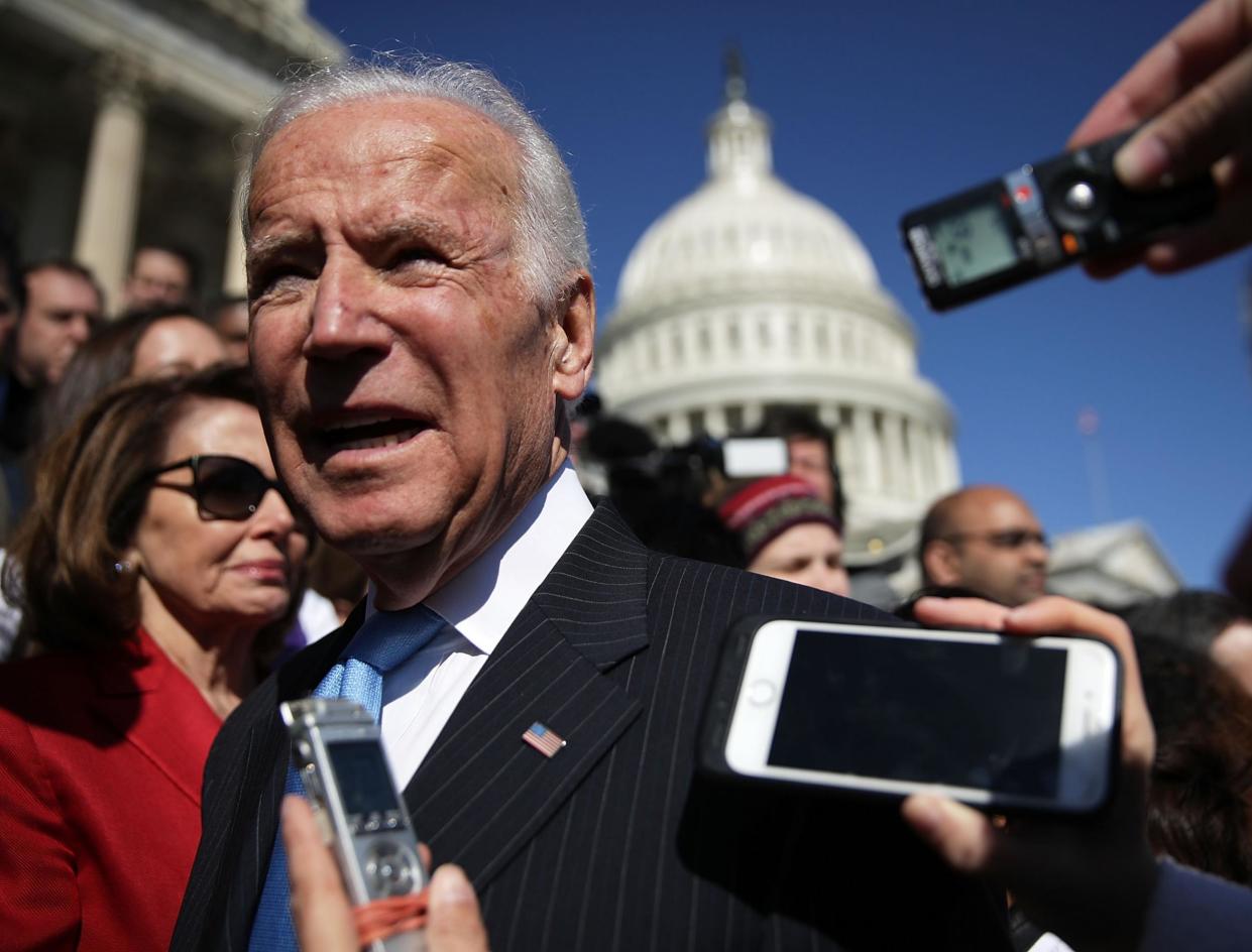 Joe Biden speak to journalists at a protest against the dismantling of Obamacare: Getty Images