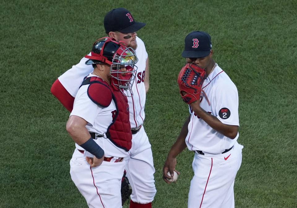 Boston Red Sox starting pitcher Brayan Bello, right, talks with catcher Christian Vazquez and third baseman Christian Arroyo between Tampa Bay Rays batters during the third inning of a baseball game at Fenway Park, Wednesday, July 6, 2022, in Boston. (AP Photo/Mary Schwalm)