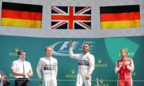 Formula One - F1 - British Grand Prix 2015 - Silverstone, England - 5/7/15 Mercedes' Lewis Hamilton celebrates his win on the podium with Nico Rosberg of Mercedes (2nd L) and Ferrari's Sebastian Vettel (R) Reuters / Paul Childs
