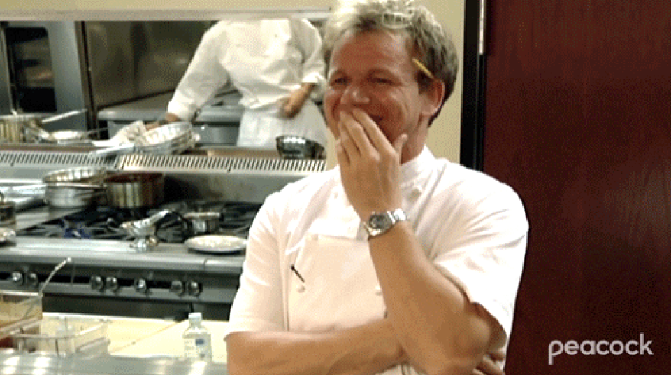 Gordon Ramsey laughing behind his hand