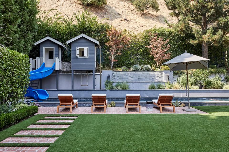 Gray tiles, a water feature, and an incredible kids’ clubhouse complete with water slide—by Craig Williams Construction—were all added to the home’s original pool area. “My son is more interested in jumping off the side, which gives me a heart attack,” says Duff. “But the kids go crazy for it.” As for the landscaping, Duff adds, “I dream of changing the brick path in the lawn—that was an O.G., original of the house—but I think it bothers me way more than it bothers other people. I will have conversations about it and they’re always like, ‘Wait, what’s wrong with it?’”