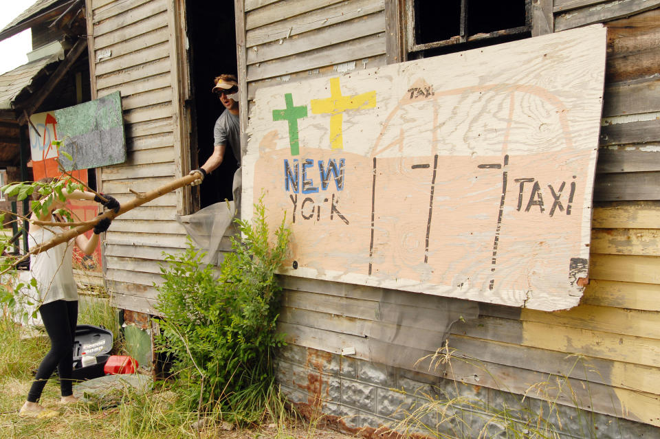 DETROIT, MI - JUNE 16: Volunteers help clean up abandoned homes as part of the Foster the People, Foster the Future: Do Good Project at Heidelberg Project on June 16, 2012 in Detroit, Michigan. (Photo by Paul Warner/Getty Images)