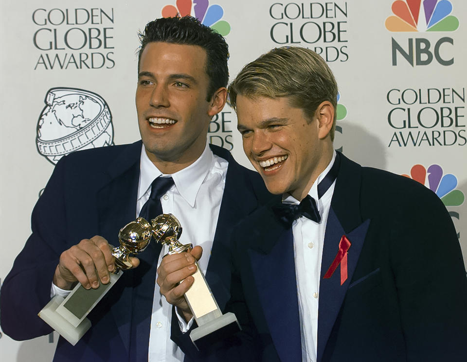 Ben Affleck and Matt Damon are photographed holding their Golden Globe Awards in 1998