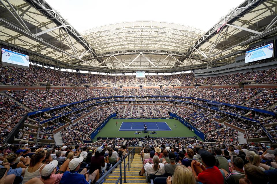 FILE - Spectators watch play between Taylor Fritz, of the United States, left, and Novak Djokovic, of Serbia, during the quarterfinals of the U.S. Open tennis championships, Tuesday, Sept. 5, 2023, in New York. An Associated Press analysis shows the average high temperatures during the U.S. Open and the three other Grand Slam tennis tournaments steadily have grown hotter and more dangerous in recent decades. (AP Photo/Manu Fernandez, File)