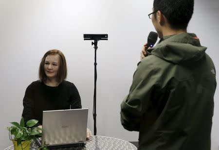 A student talks to Nadine, a humanoid created by Nanyang Technological University's (NTU) Professor Nadia Thalmann and her team, at their campus in Singapore March 1, 2016. REUTERS/Edgar Su