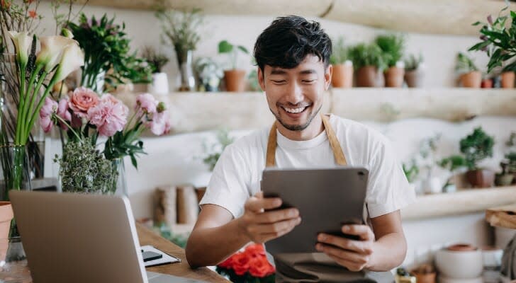 A business owner looks over his investment portfolio on his tablet. John Hancock has launched a new preferred income ETF that invests heavily and preferred stock and other income-producing assets. 